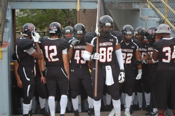 Senior Richard King holds RHS flag before battle with Westminster 