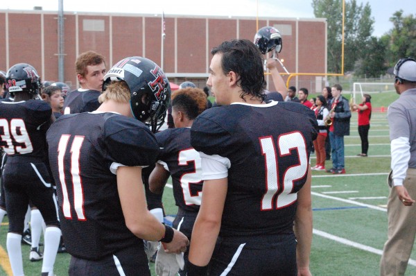 (Kane Vigil, 11 and Quaid Vincent, 12, talk on the sideline. Photo by Bri Garcia)