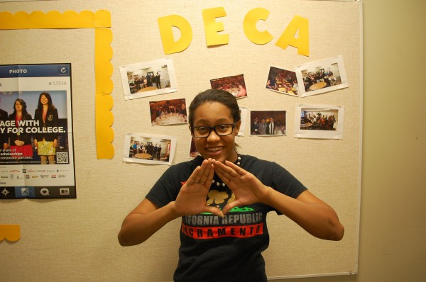 DECA treasurer Rynieka Knight putting up the DECA Star (Briana Garcia)