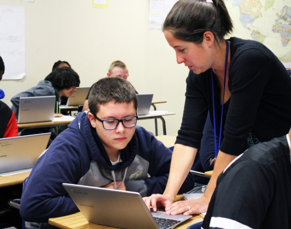 Mrs.Gebhardt+helps+students+with++technology+in+the+classroom.
