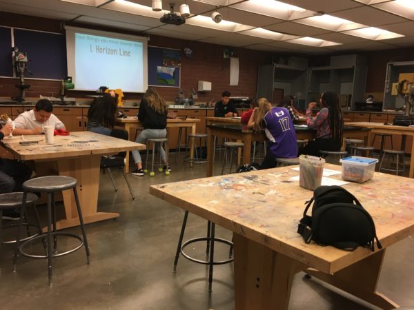 Feature photo by: Savannah Lyman- Students in drawing 2 art class took notes during a presentation. Classes are half empty due to the Junior's CMAS testing and 24 minute class periods. Only 30% or less of Juniors showed up to take the standardized science test. 