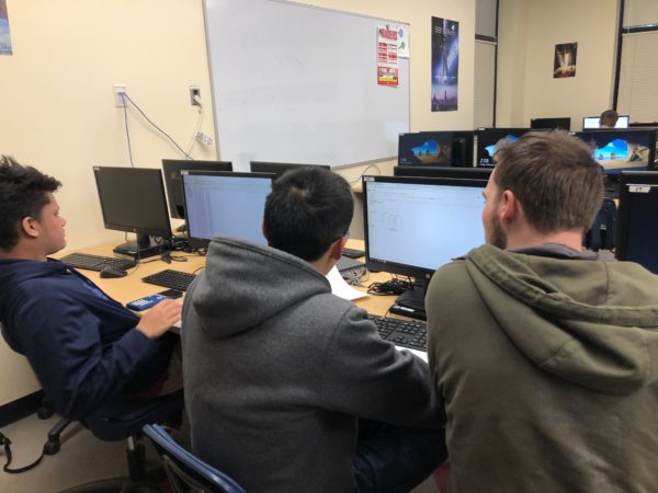 Juniors David (DJ) Guzman, Charles Hulongbayan and senior Kenny Luong work side by side. The 150 teams come from all over including Japan, Germany, Guam, and Alaska. (Nealani Elliston)
