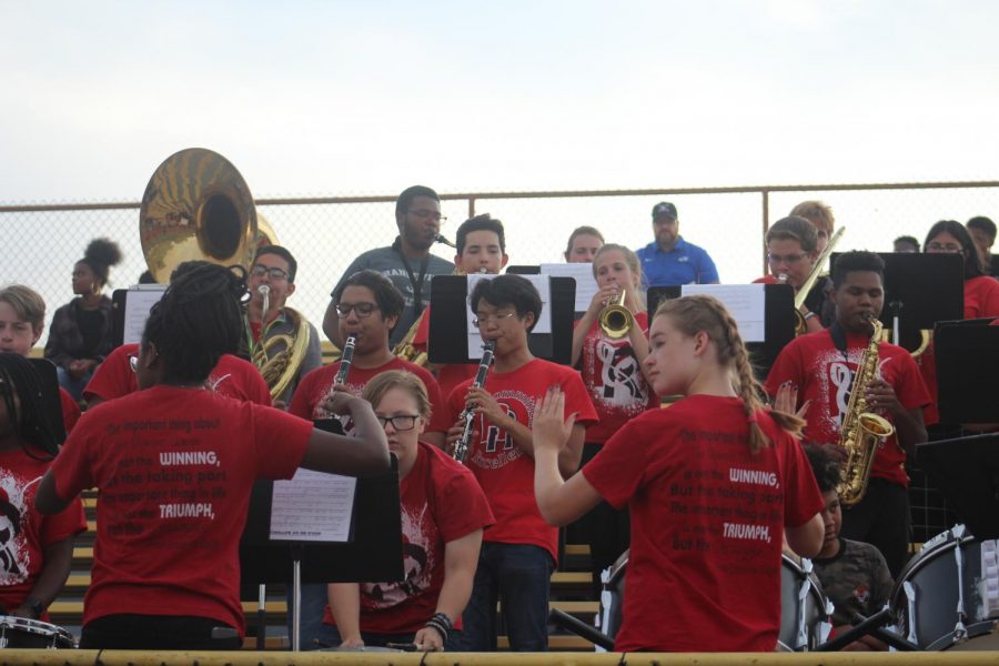 On the left, Senior Aida Wates and on the right, Senior Katie Finell conduct the band while they played the RHS Fight Song after a touchdown on the football game on Thursday.