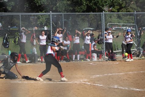 Senior Janeigh De La Paz steps up and swings in the first game of the season vs. Kennedy. Rangeview won with an ending score of 12-8.