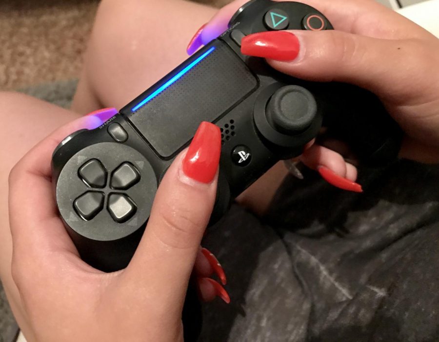 A PlayStation controller feels so familiar in the hands of most students. Many are familiar with video games, and the violence that many of them contain. (Dylan Tressider)