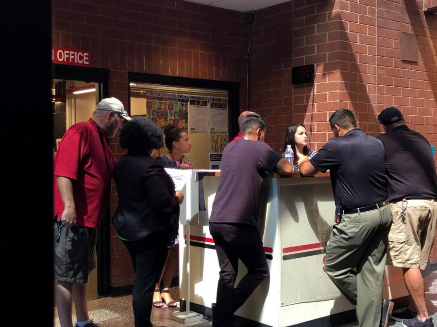 Some of the security administration meet at the front lobby desk discussing matters. Many watch the halls and rotate through checking different areas of the school at different times. (Stephanie Pickens)