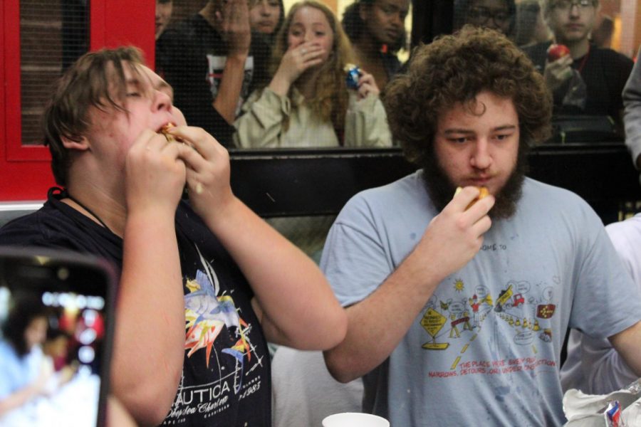 Senior Baily Morgan finishes his second hot dog as junior Trevor Murray focuses on swallowing half of his second. It wasnt that hard because Ive done a hot dog eating contest before, said Morgan.