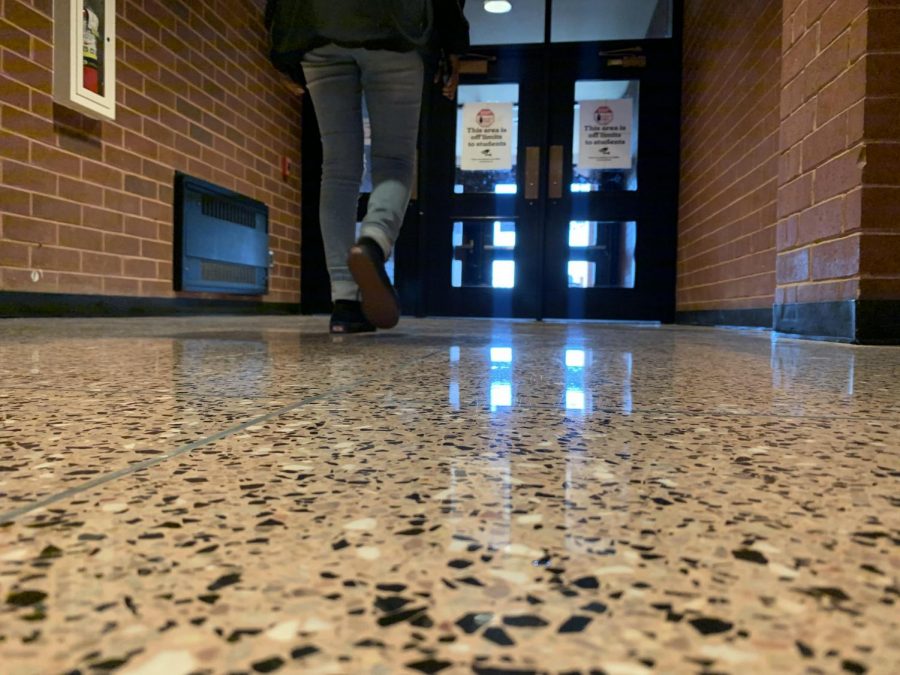 Blessed Asare walks through the “off limits” door after the 3:21 bell rings. Students throughout the school use these doors to exit the building faster than leaving by the front entrance. 