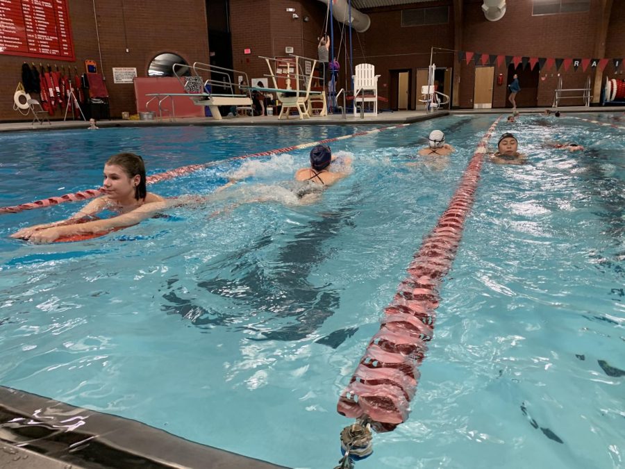 The girls swim team at practice on December 10th. The girls had a kick drill that day. (Katiana Williams) 