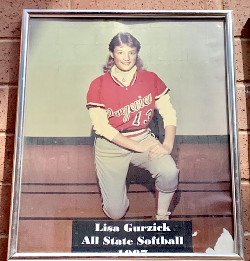Grosz’s picture from her successful softball career hangs in the hallway by the large gym. It reads “All State Softball”. (Caroline Smith)