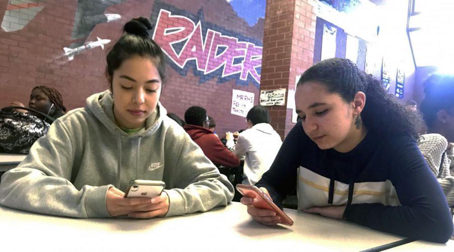 Feature Photo by: Melanie Aguirre - Denise Arreola (left) and Marwa Ait Chafhi (right) spend lunch together as they go through their social media. 