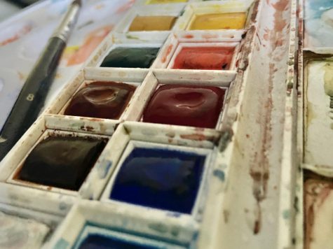 Watercolor paints rest in a pallet. Watercolors are dried blocks of paint that can be reused over and over again. (Hera Pokheral)
