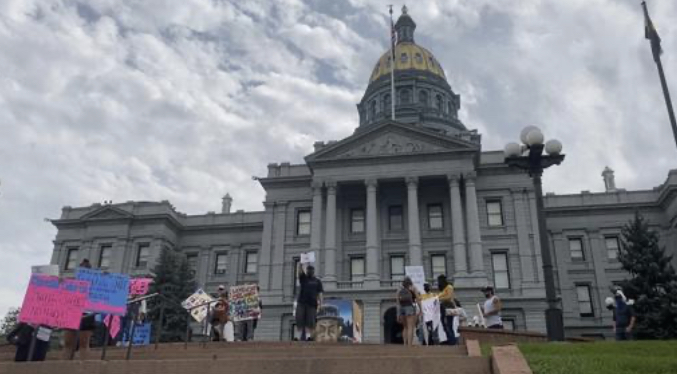 A small amount of citizens are gathered at the Capitol in Denver to spread awareness about human trafficking (NewsBreak)