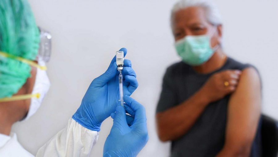 Nurse preparing a needle to give a patient a shot in the arm. (Photo by news.gallup.com)