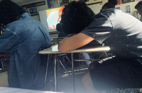 Student sleeping on desk during class (Photo Credit - Joslyn Bowman) 