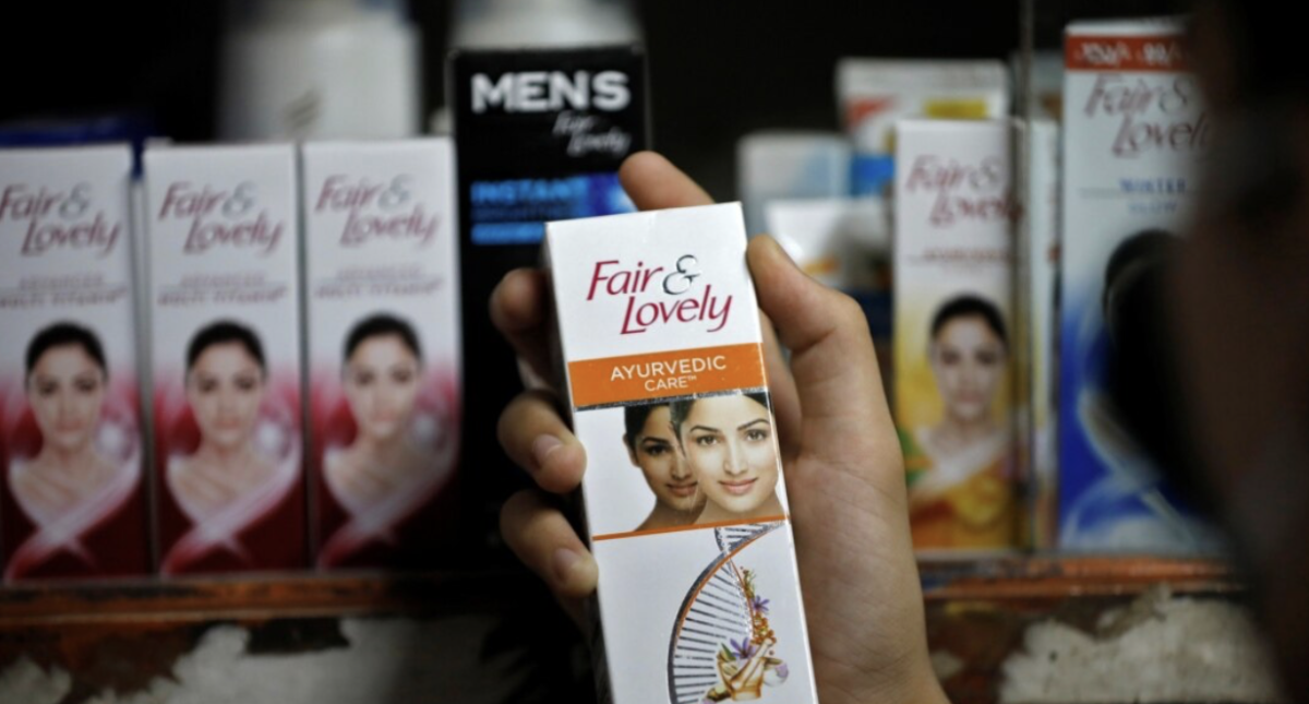 A customer picks up a 'Fair & Lovely' brand of skin-lightening product from a shelf in a shop in Ahmedabad, India, June 25, 2020.